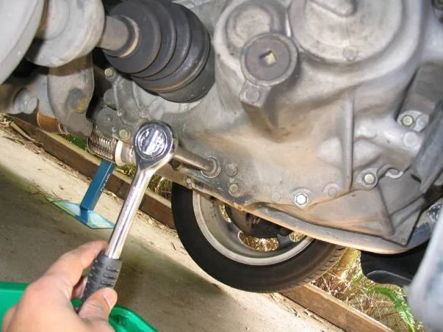 Raise the car and drain the gearbox oil